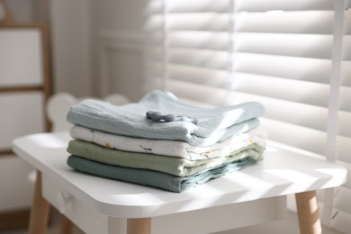 Baby swaddles and teether on table indoors