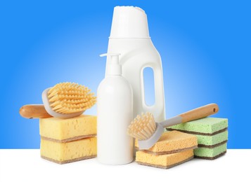 Image of Eco-friendly cleaning products on white table against light blue gradient background