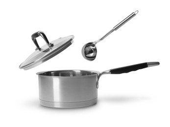 Image of Ladle and lid in air over saucepan on white background