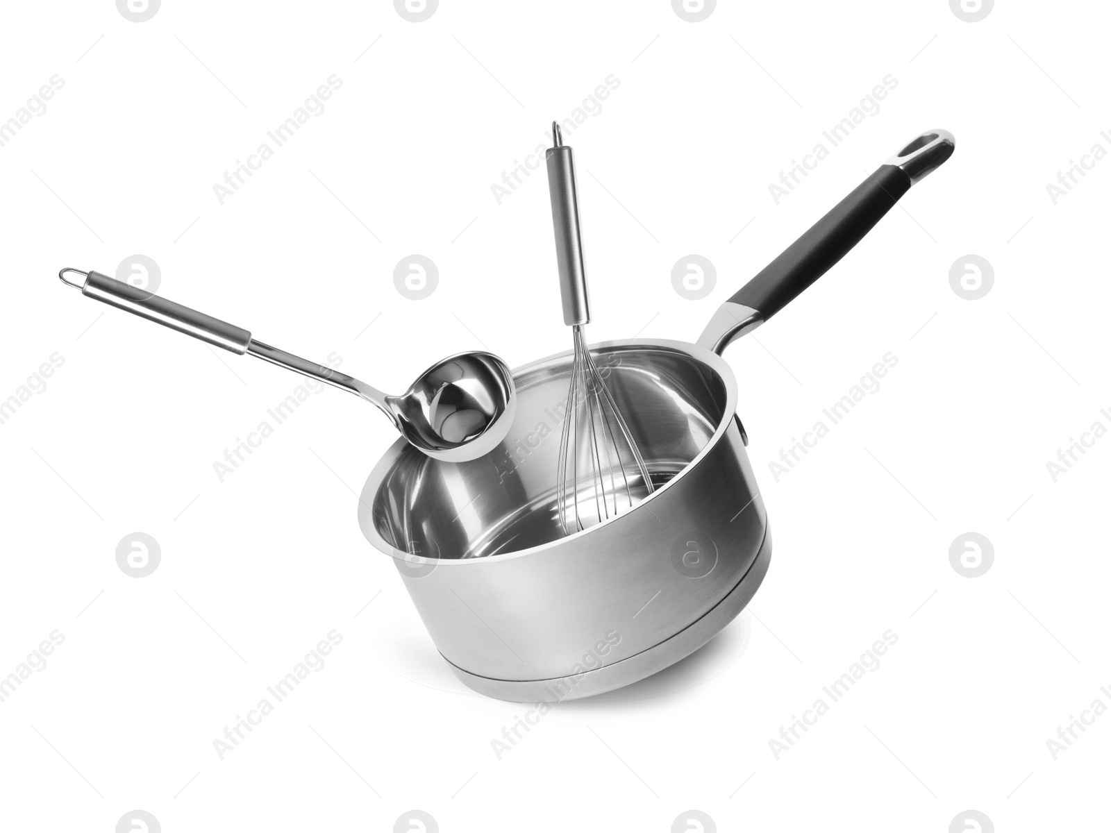 Image of Saucepan, ladle and whisk in air on white background
