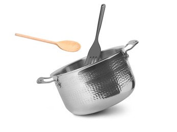 Image of Saucepan, wooden spoon and slotted spatula in air on white background