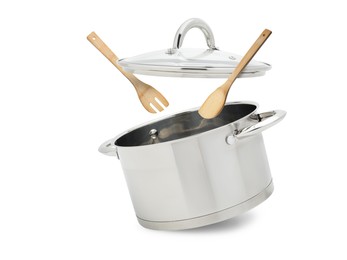 Image of Saucepan, wooden spoon and turner in air on white background