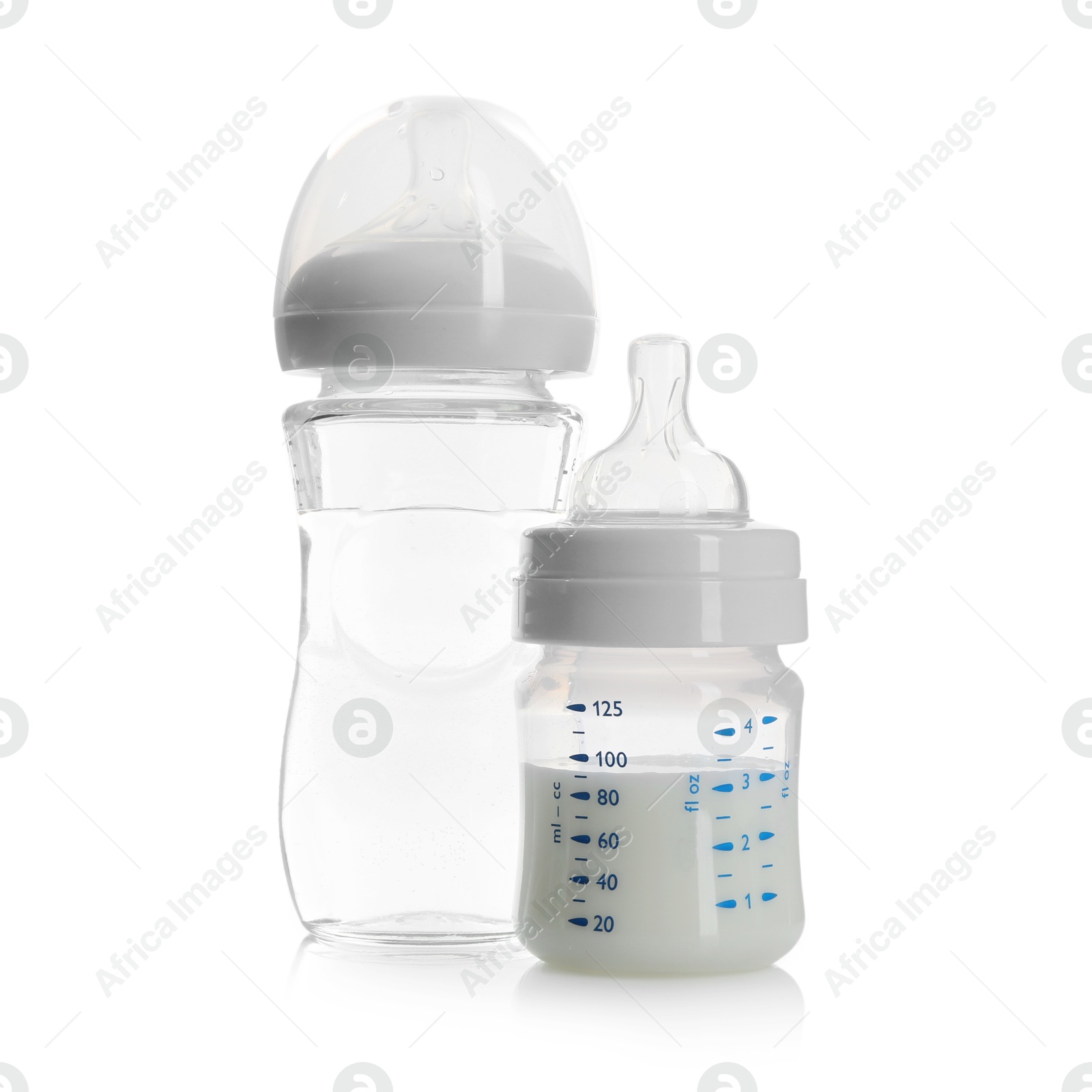 Photo of Feeding bottles with milk and water isolated on white