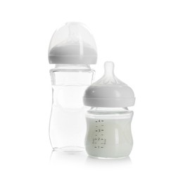 Photo of Feeding bottles with milk and water isolated on white