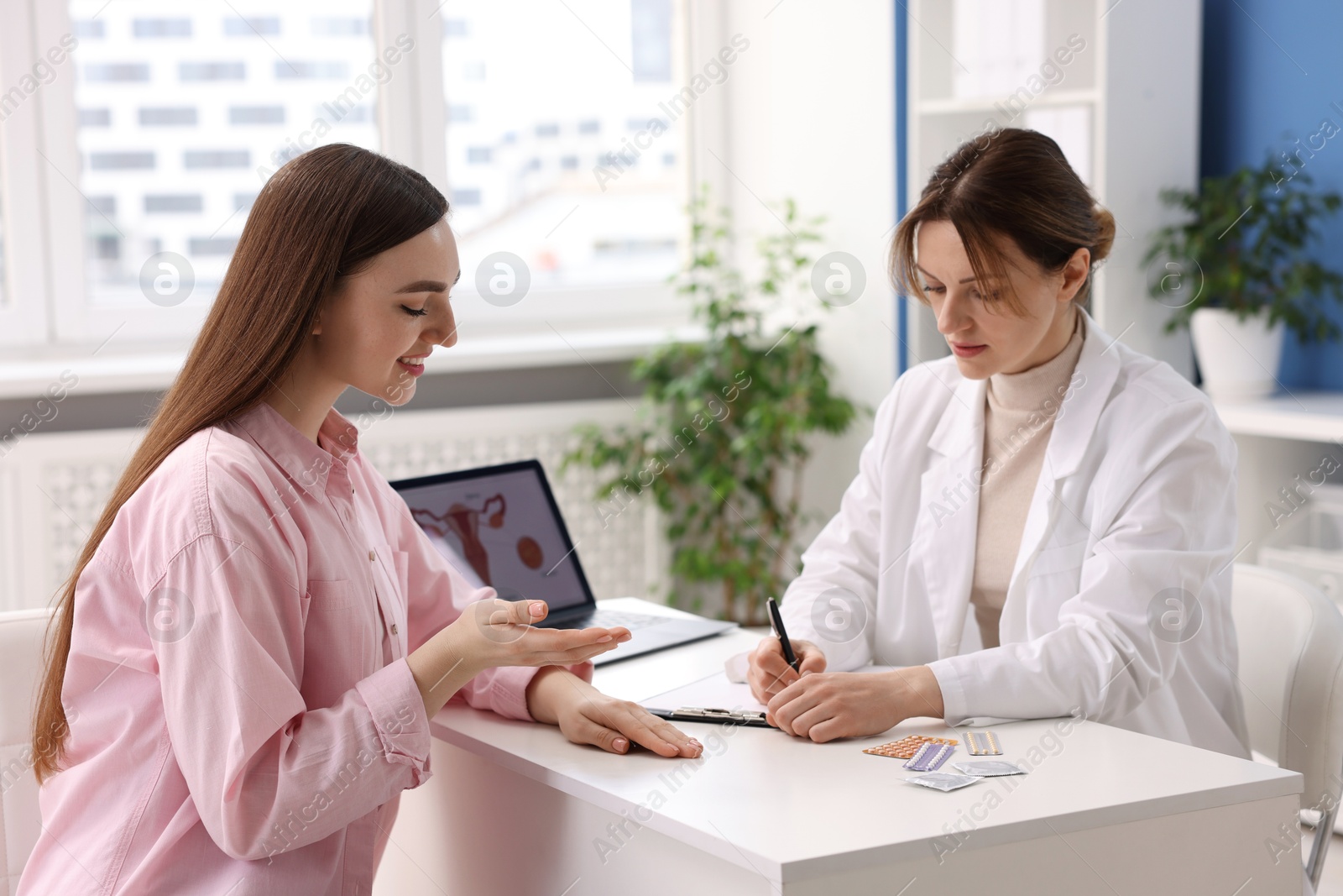 Photo of Contraception. Woman having appointment with gynecologist in clinic