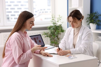 Photo of Contraception. Woman having appointment with gynecologist in clinic