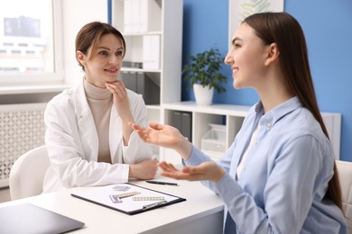 Photo of Contraception. Woman having appointment with gynecologist in clinic