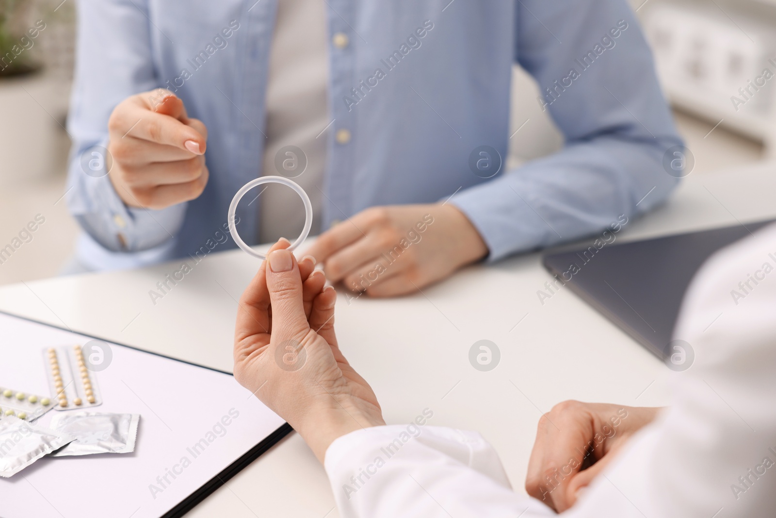 Photo of Contraception. Gynecologist recommending vaginal ring to woman in clinic, closeup