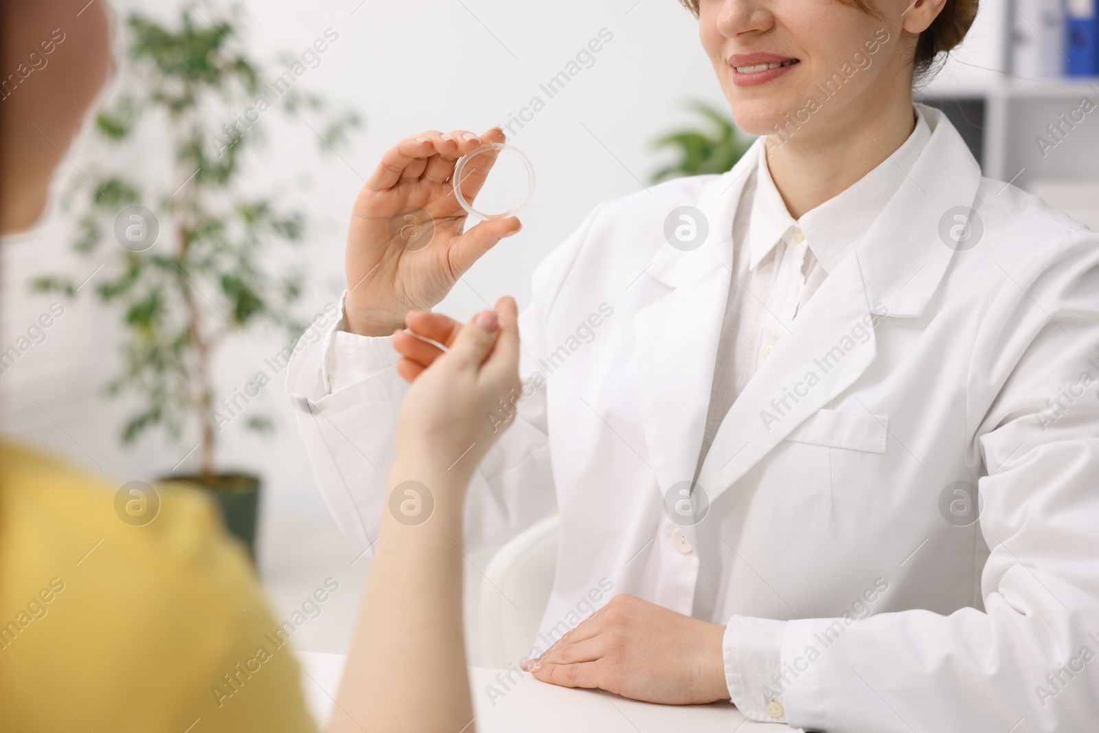 Photo of Contraception. Gynecologist recommending vaginal ring to woman in clinic, closeup