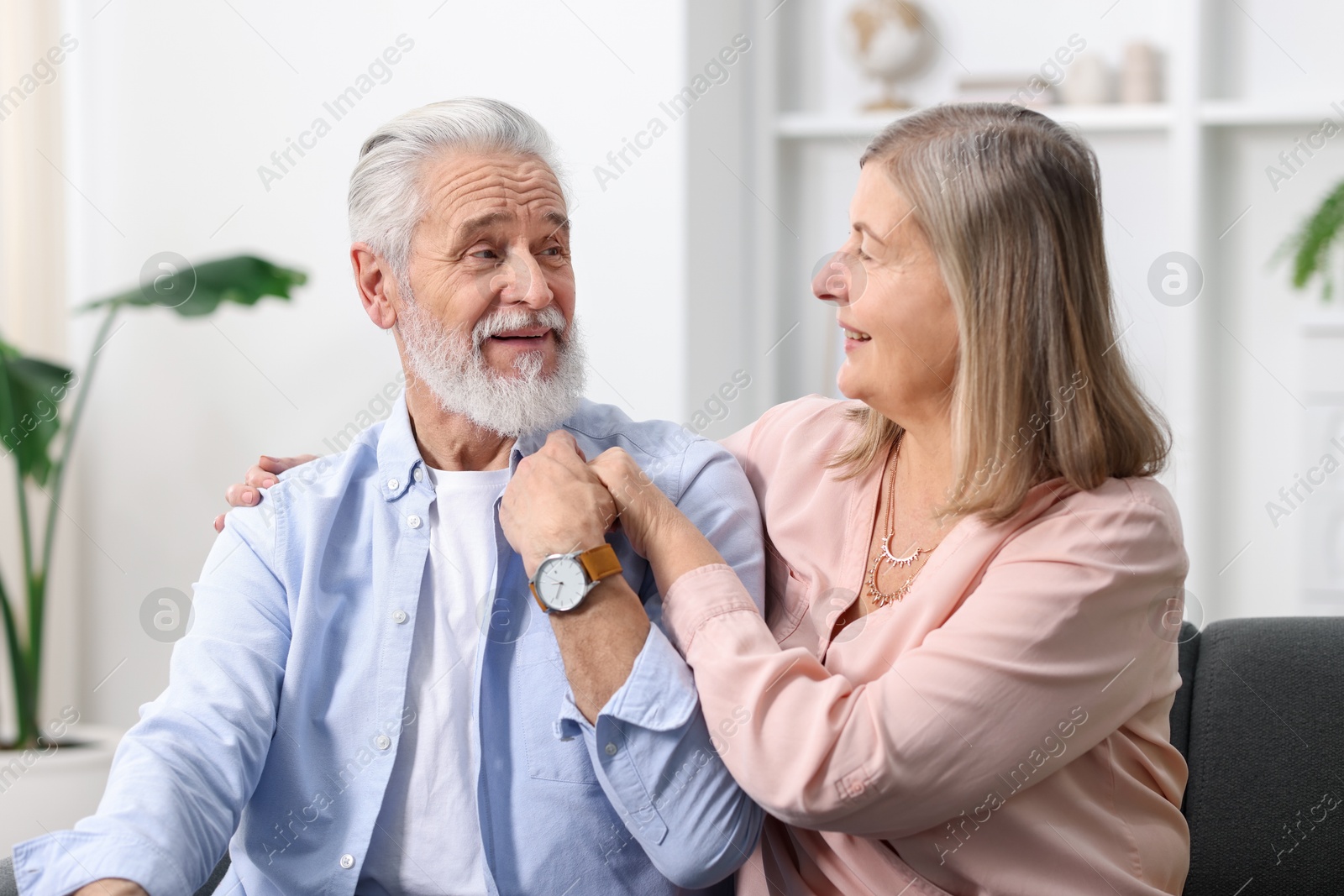 Photo of Happy elderly couple looking at each other at home