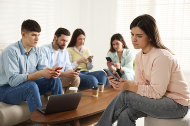 Internet addiction. Group of friends with gadgets and coffee at table indoors