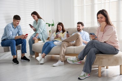 Internet addiction. Group of people with smartphones on sofa indoors