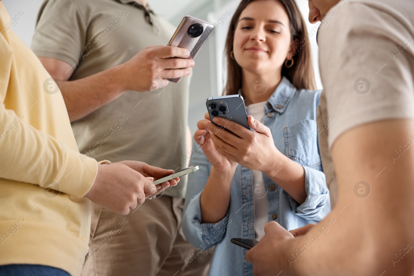 Photo of Internet addiction. Group of people with smartphones indoors, closeup