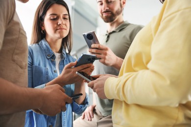 Internet addiction. Group of people with smartphones indoors, closeup