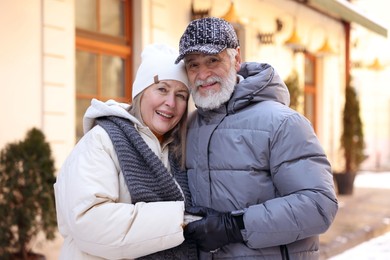 Photo of Family portrait of happy elderly couple on city street