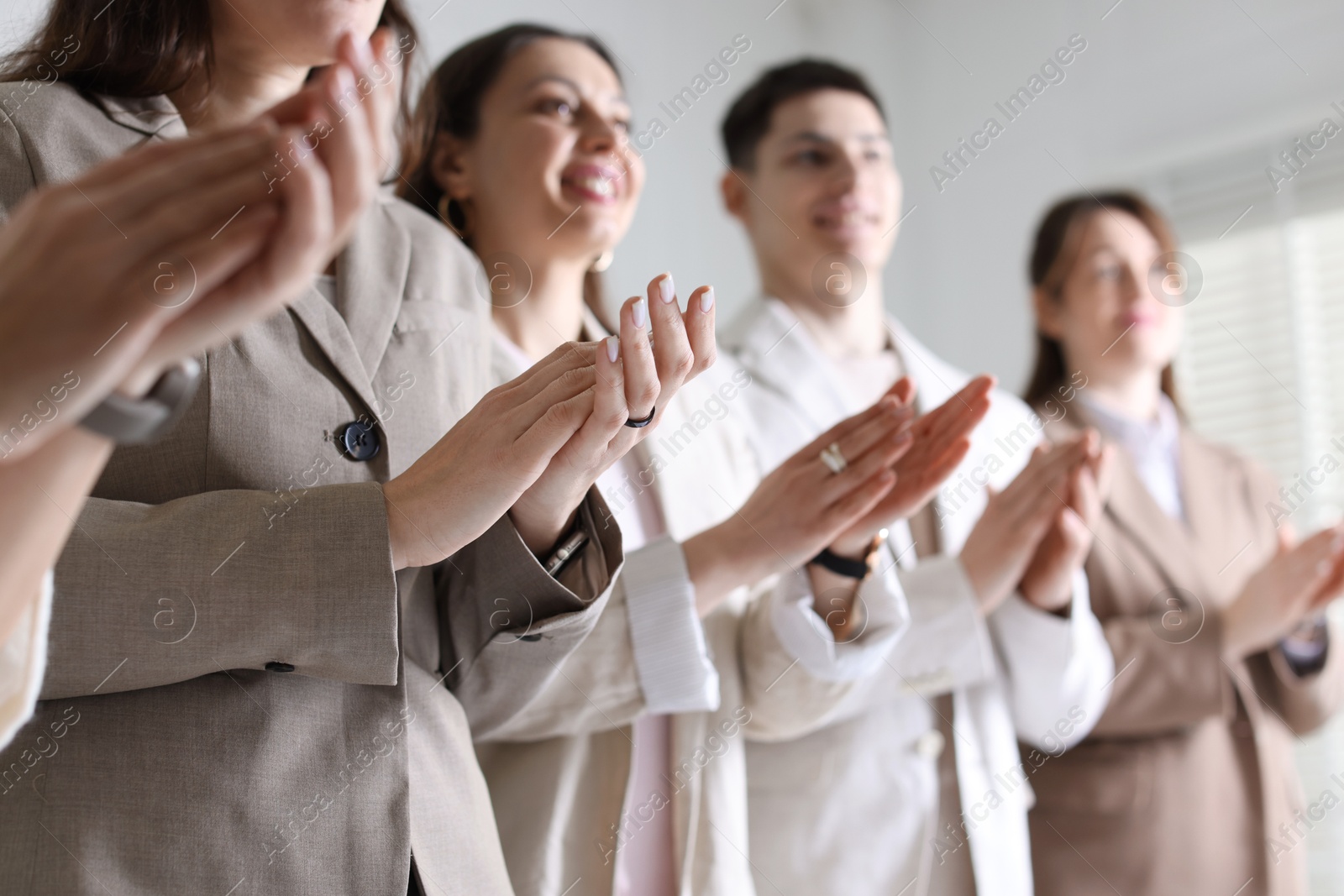 Photo of People applauding during meeting indoors, closeup view