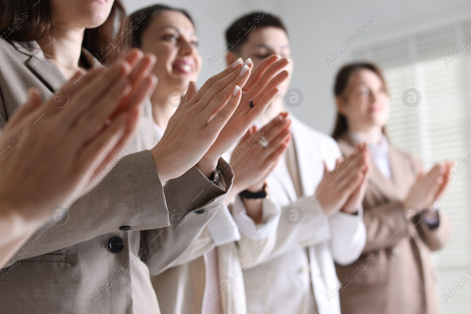 Photo of People applauding during meeting indoors, closeup view