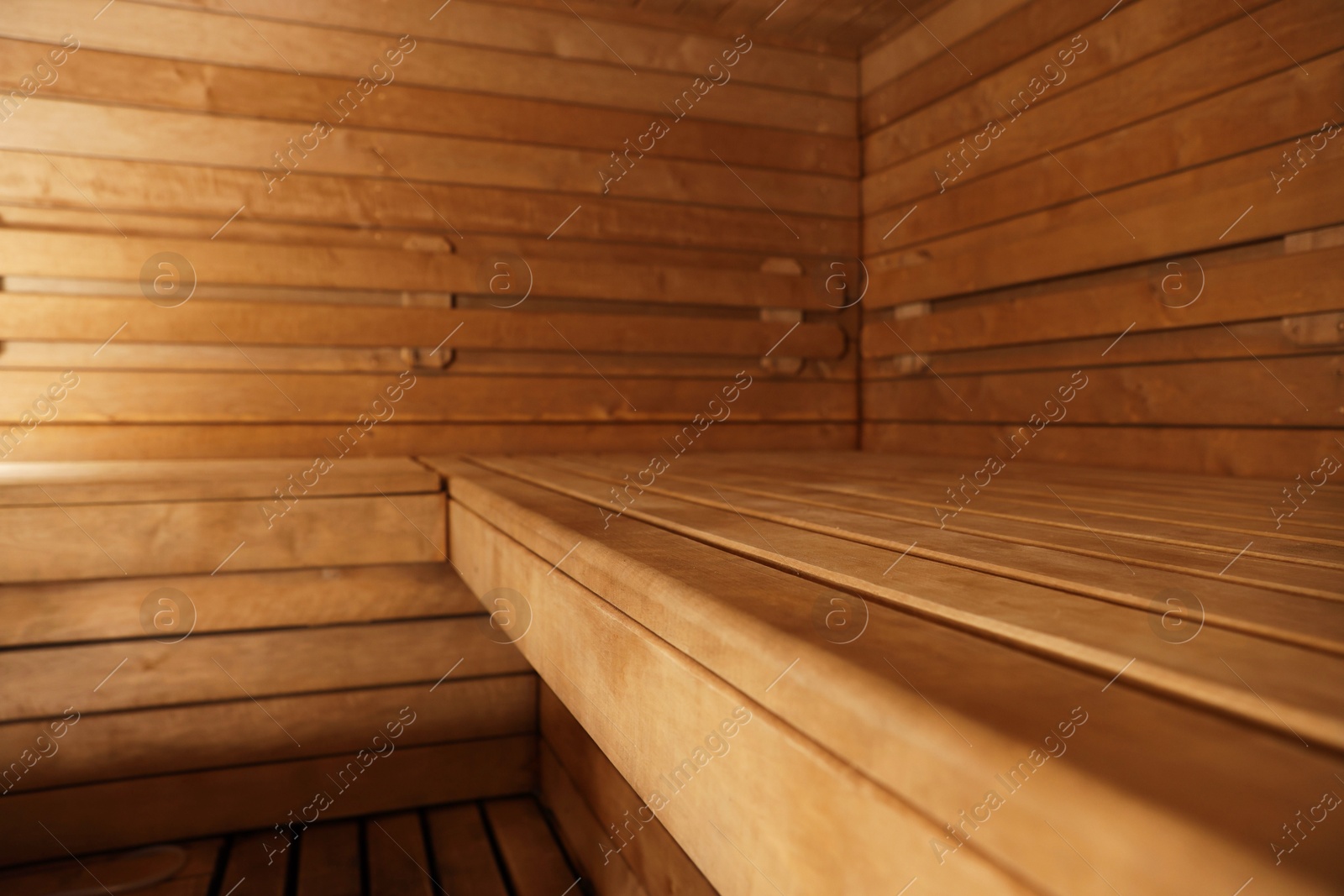 Photo of Empty wooden sauna with bench. Luxury relax