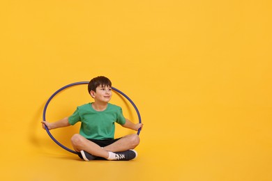 Photo of Boy with hula hoop on yellow background, space for text