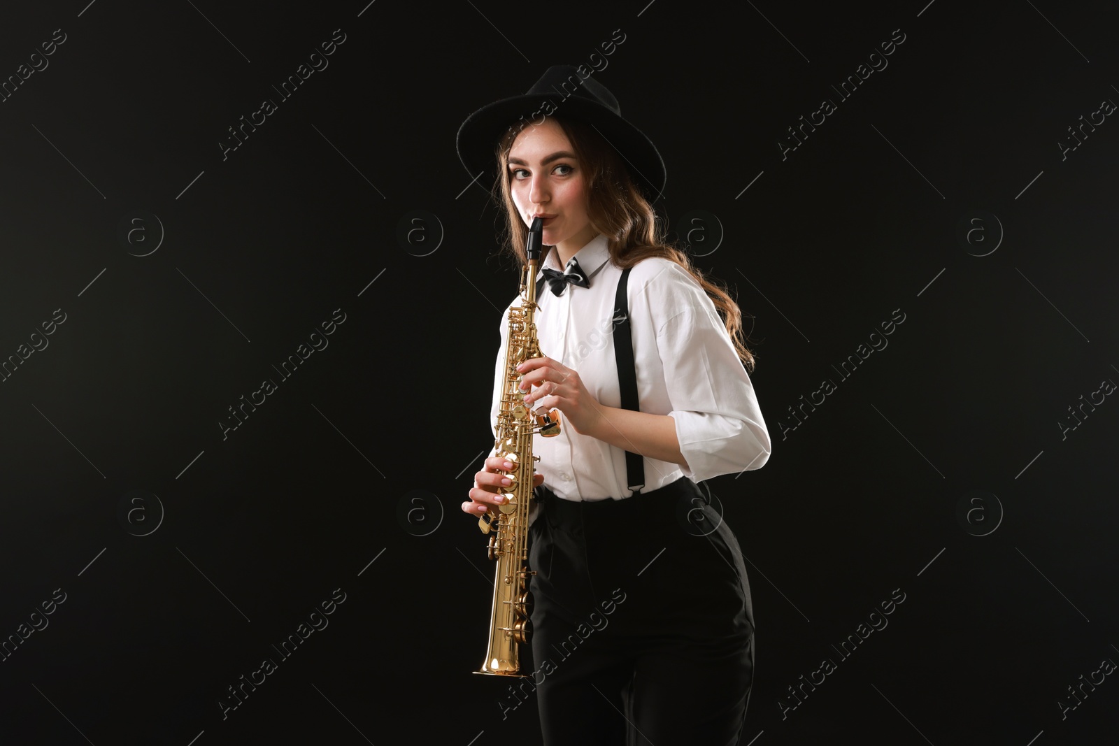 Photo of Musician playing soprano saxophone on dark background