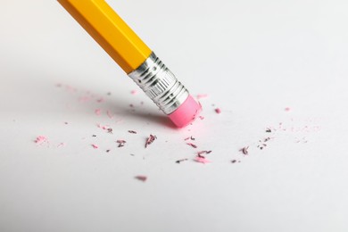 Photo of Using pencil with eraser on white sheet of paper, closeup