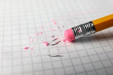 Photo of Using pencil with eraser on white sheet of paper, closeup