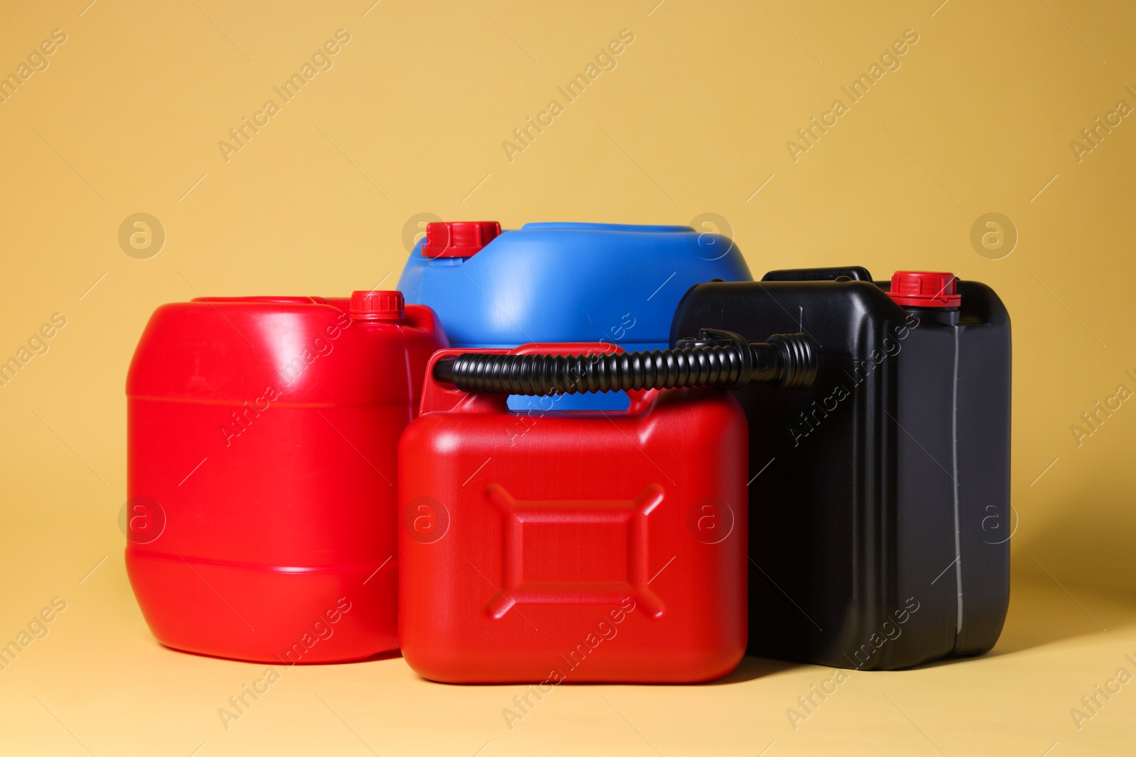 Photo of Many different plastic canisters on yellow background