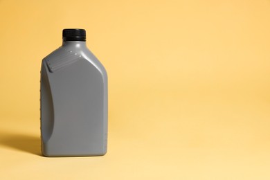 One grey plastic canister on yellow background, space for text