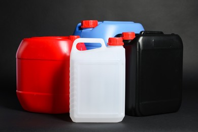 Many different plastic canisters on black background