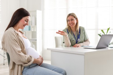 Pregnant woman having appointment with doctor in clinic