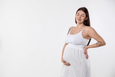 Beautiful pregnant woman with cute belly on white background. Space for text