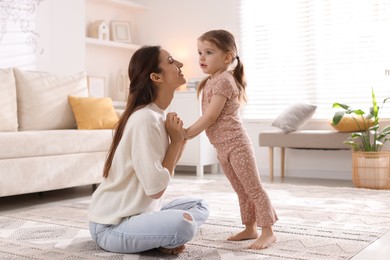 Photo of Happy mother with her cute little daughter at home