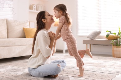 Photo of Happy mother with her cute little daughter at home