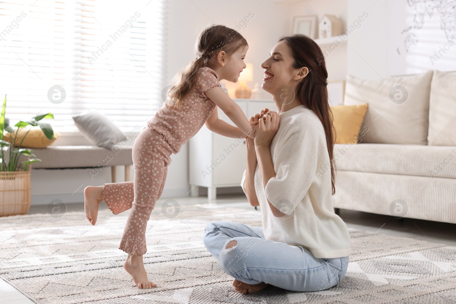 Photo of Happy mother with her cute little daughter at home