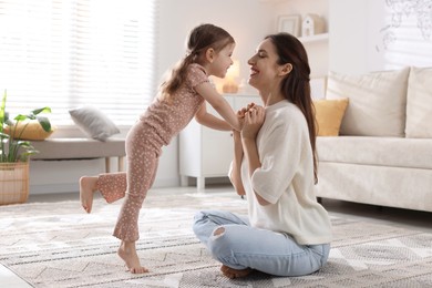 Photo of Happy mother with her cute little daughter at home