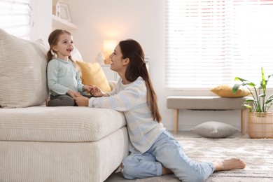 Photo of Happy mother with her cute little daughter at home