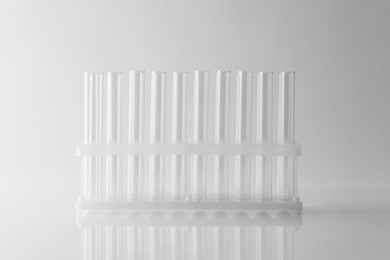 Photo of Empty test tubes on light background. Laboratory glassware