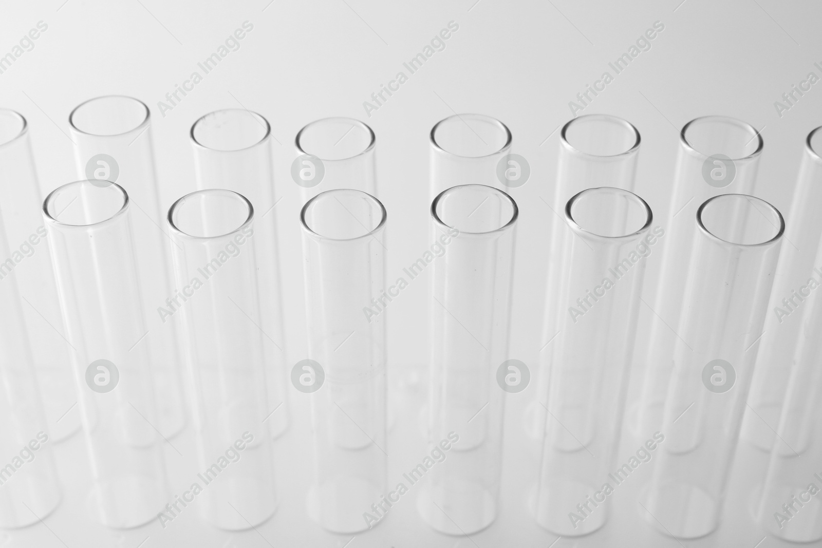 Photo of Empty test tubes on light background, closeup. Laboratory glassware