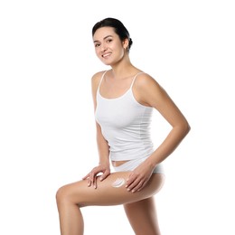 Woman applying anti cellulite cream on white background