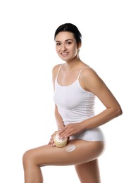 Woman applying anti cellulite cream on white background