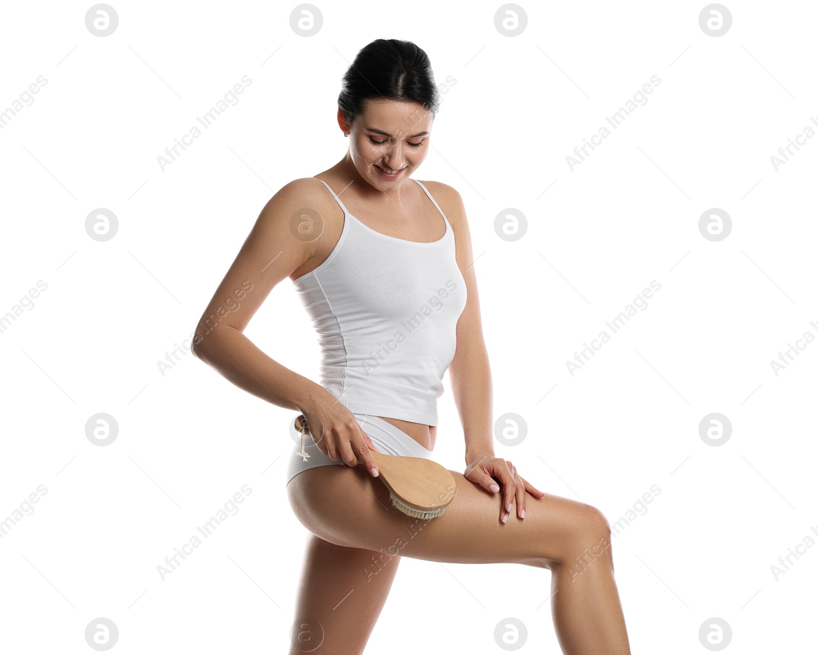 Photo of Woman doing anti cellulite massage with brush on white background