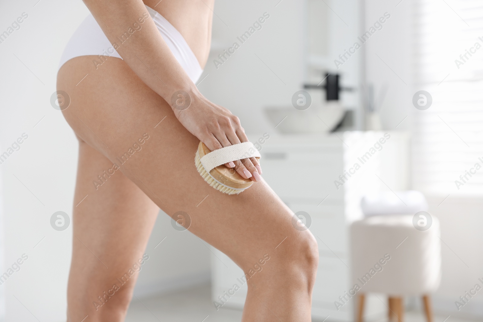 Photo of Woman doing anti cellulite massage with brush indoors, closeup. Space for text