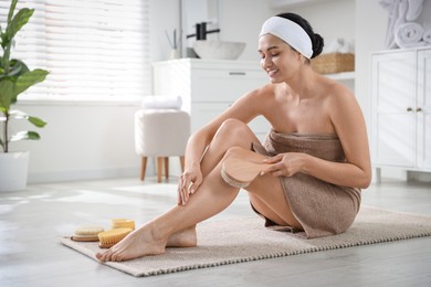 Photo of Woman doing anti cellulite massage with brush indoors. Space for text