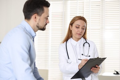 Photo of Man having appointment with cardiologist in clinic