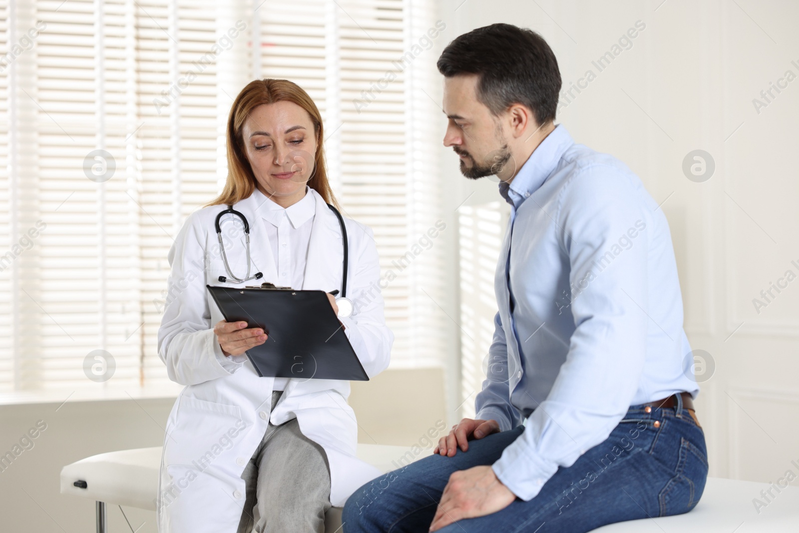 Photo of Man having appointment with cardiologist in clinic