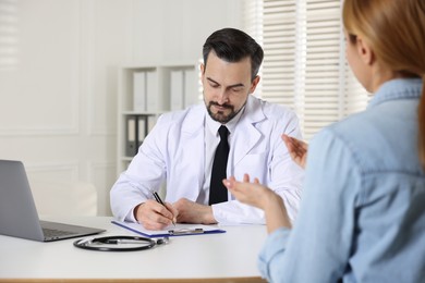 Photo of Woman having appointment with cardiologist in clinic