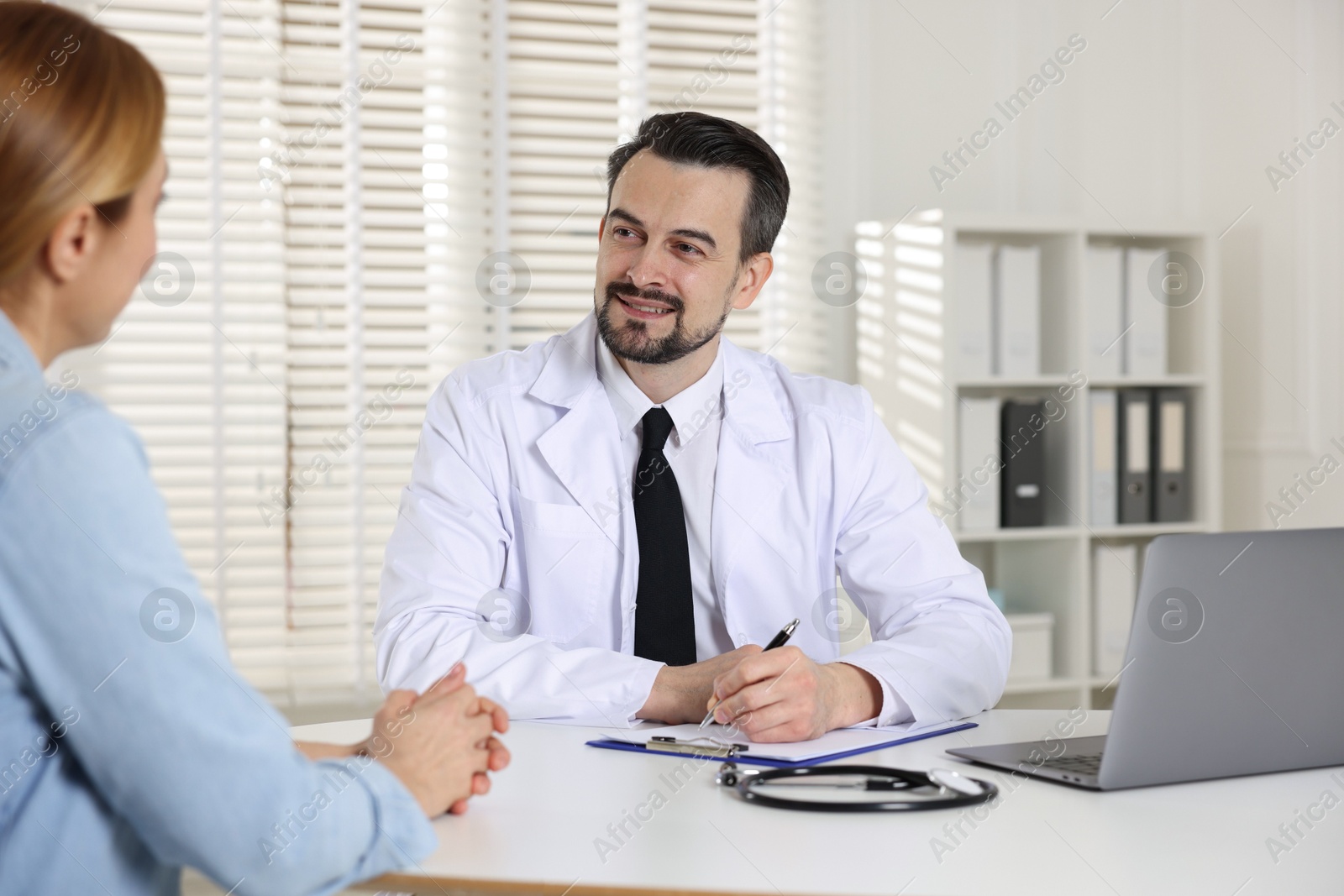 Photo of Woman having appointment with cardiologist in clinic