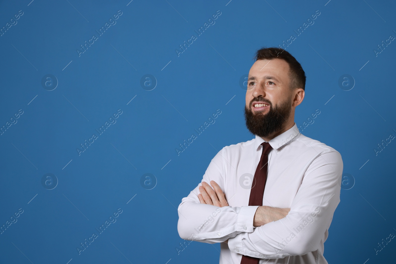 Photo of Handsome bearded man in formal outfit on blue background. Space for text