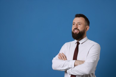 Photo of Handsome bearded man in formal outfit on blue background. Space for text