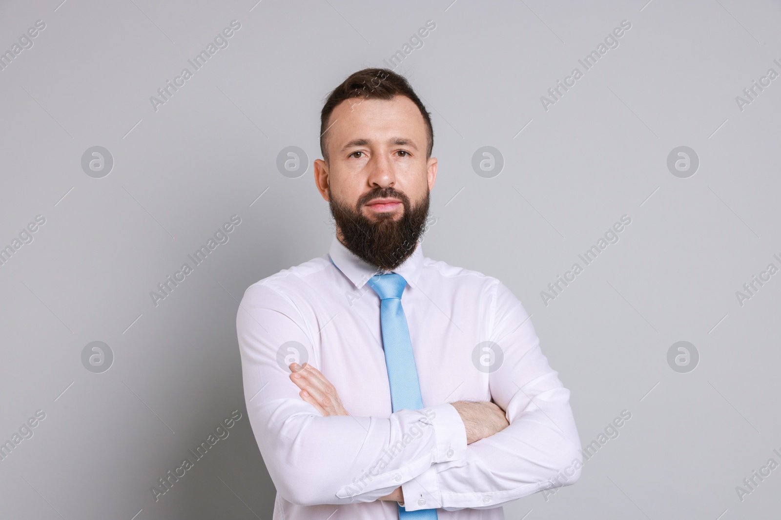 Photo of Handsome bearded man in formal outfit on grey background